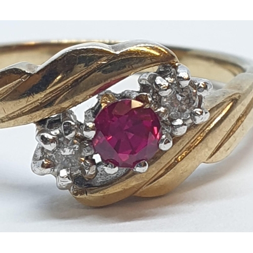 82 - 9ct Yellow gold three stone diamond and ruby ring. Weight 3g, Size N.