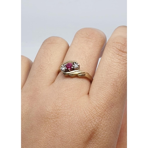 82 - 9ct Yellow gold three stone diamond and ruby ring. Weight 3g, Size N.