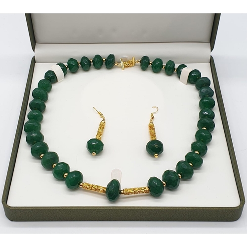 150 - A multifaceted, large beaded, opaque emerald necklace and earrings set in a presentation box. Neckla... 