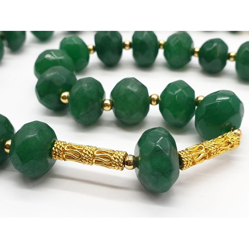 150 - A multifaceted, large beaded, opaque emerald necklace and earrings set in a presentation box. Neckla... 