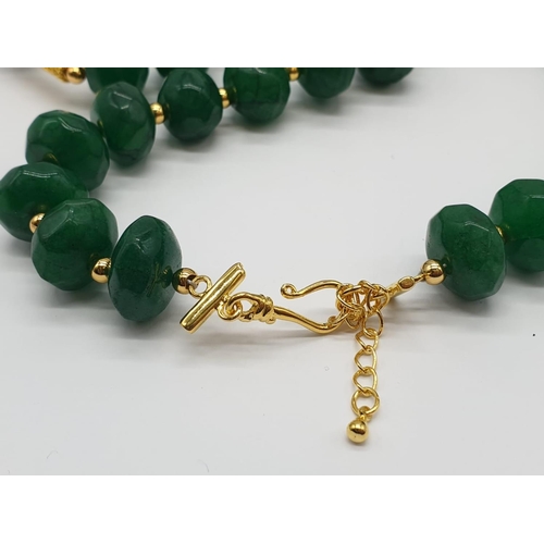 150 - A multifaceted, large beaded, opaque emerald necklace and earrings set in a presentation box. Neckla... 