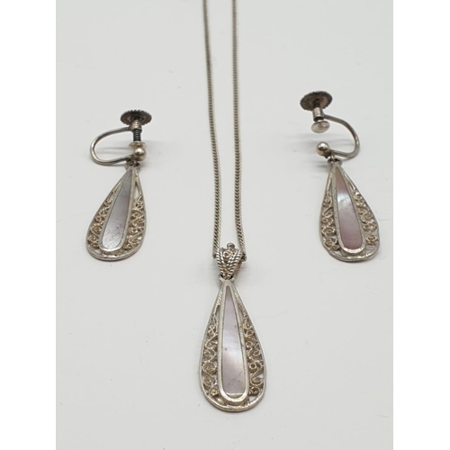 895 - Silver jewellery set to include pendant on chain and matching pair of earrings. 
Mother of pearl des... 