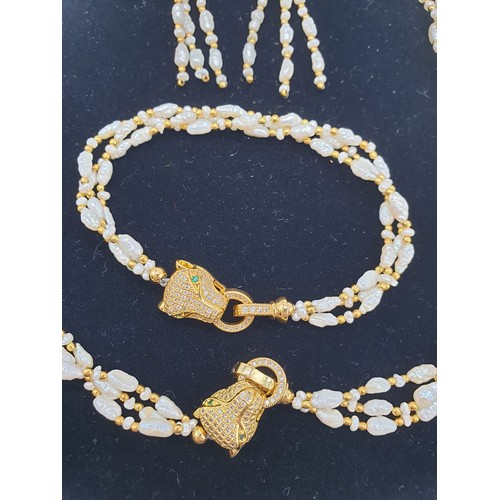 97 - A Cartier style pearl necklace, bracelet and earrings set in a presentation box. Necklace length: 53... 