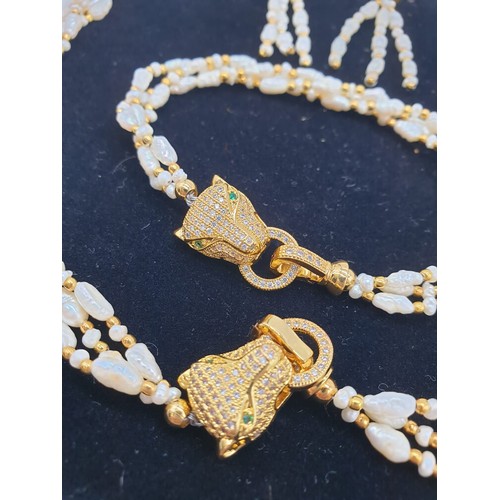 97 - A Cartier style pearl necklace, bracelet and earrings set in a presentation box. Necklace length: 53... 