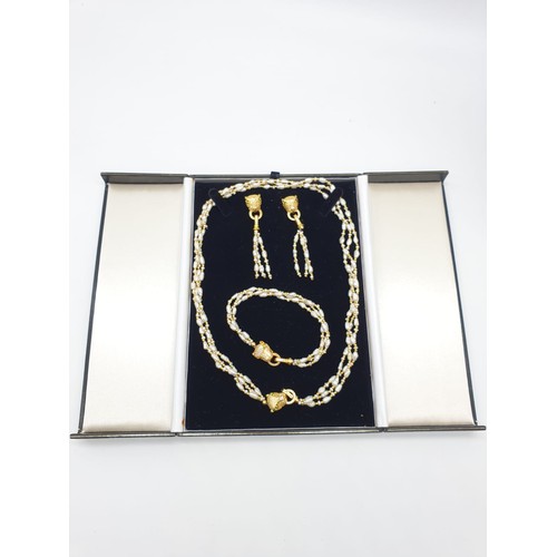 97 - A Cartier style pearl necklace, bracelet and earrings set in a presentation box. Necklace length: 53... 
