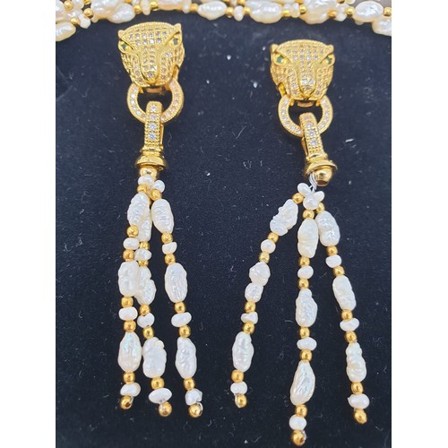 97 - A Cartier style pearl necklace, bracelet and earrings set in a presentation box. Necklace length: 53... 