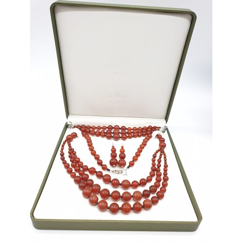 90 - A three rows of round polished carnelian, necklace, bracelet and earrings set in a presentation box.... 