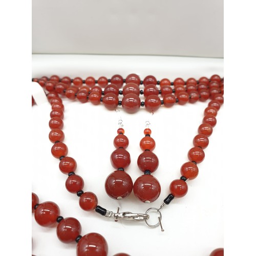 90 - A three rows of round polished carnelian, necklace, bracelet and earrings set in a presentation box.... 