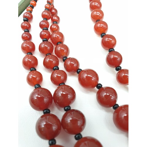 90 - A three rows of round polished carnelian, necklace, bracelet and earrings set in a presentation box.... 