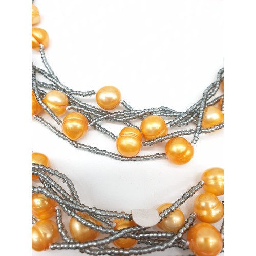 40 - A very unusual necklace and bracelet set with large yellow-orange pearls. In a presentation box. Nec... 