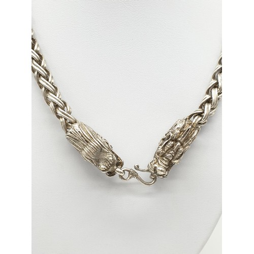 60 - A Tibetan silver, braded chain, necklace with two Chinese dragon heads. Necklace length: 68cm, weigh... 