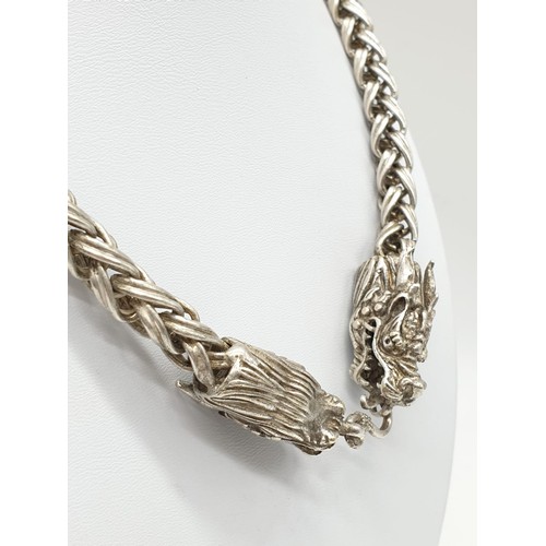 60 - A Tibetan silver, braded chain, necklace with two Chinese dragon heads. Necklace length: 68cm, weigh... 