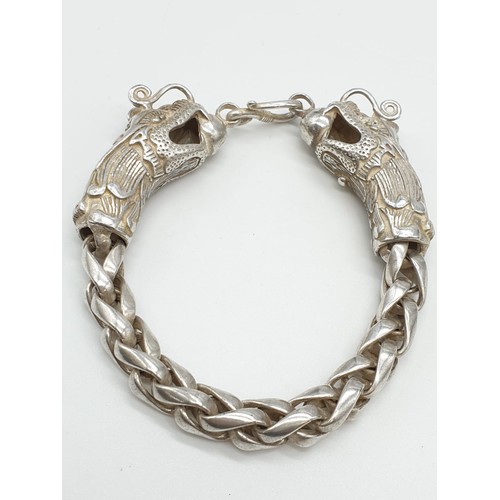 61 - A Tibetan silver, braded chain, bracelet with two Chinese dragon heads Bracelet length: 22cm, weight... 