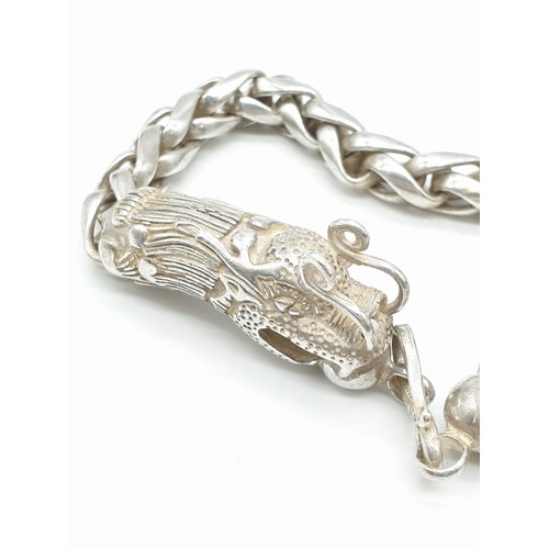 61 - A Tibetan silver, braded chain, bracelet with two Chinese dragon heads Bracelet length: 22cm, weight... 