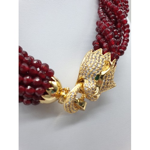 30 - A 15 row statement necklace with faceted rubies and a large Cartier Panther style clasp. Rubies are ... 