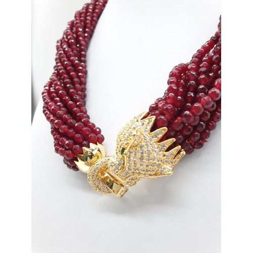 30 - A 15 row statement necklace with faceted rubies and a large Cartier Panther style clasp. Rubies are ... 