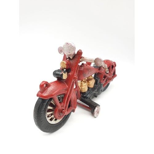 20 - A collector’s item, French, cast iron, MITCHELIN MAN, on a motorbike. Wheels turning with special so... 