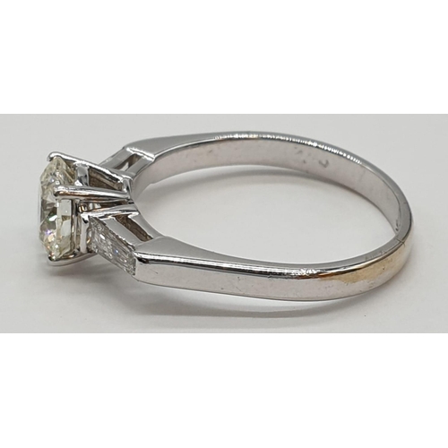 27 - 14ct white gold ring with 1.02ct diamond centre (colour J, clarity VS1) and 2 baguette cut diamonds ... 