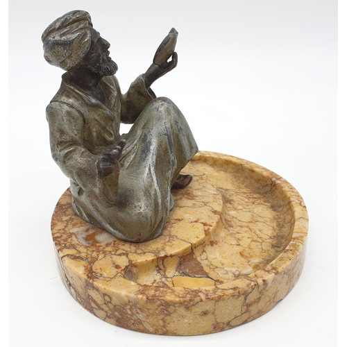 44 - Ashtray of a Moroccan preacher man figurine on a marble base. Height 11cm.