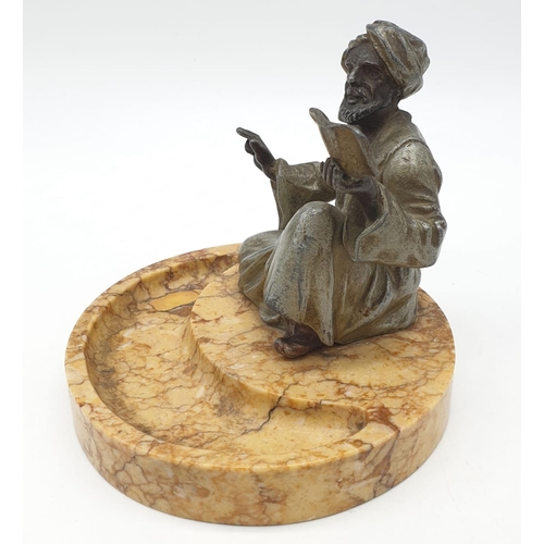 44 - Ashtray of a Moroccan preacher man figurine on a marble base. Height 11cm.