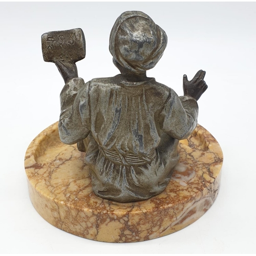 44 - Ashtray of a Moroccan preacher man figurine on a marble base. Height 11cm.