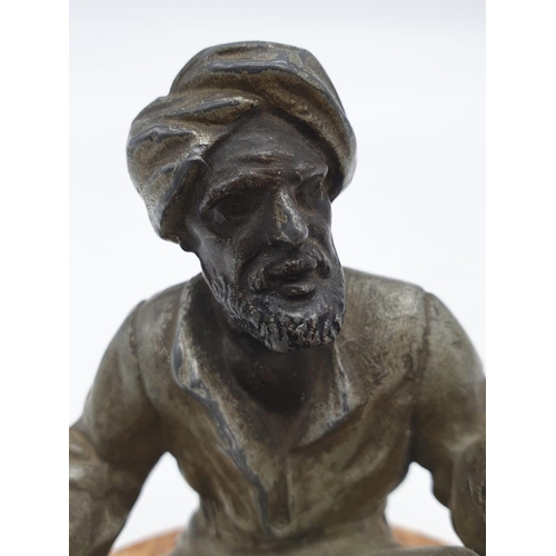 44 - Ashtray of a Moroccan preacher man figurine on a marble base. Height 11cm.