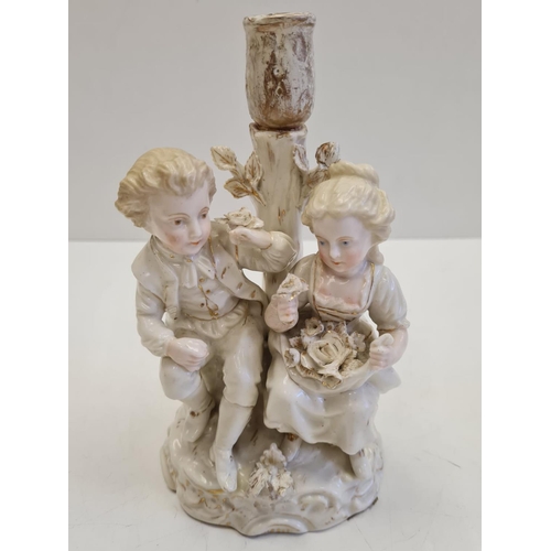 72 - Pair of ceramic candlesticks with figures in Victorian themed fashion. Height 19cm.