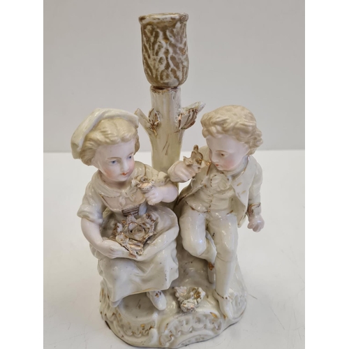 72 - Pair of ceramic candlesticks with figures in Victorian themed fashion. Height 19cm.