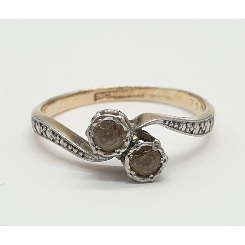 39 - 9ct Gold and platinum ring having two pale aqua stones to top in crossover style. Presented in ring ... 