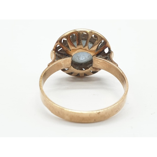 28 - Vintage 14ct gold ring having large circular aquamarine stone to top with pierced design brim surrou... 