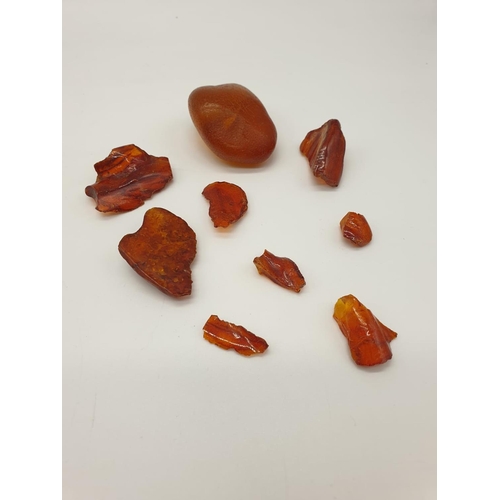 606 - 9x pieces of rough ambers, weight 74.4g