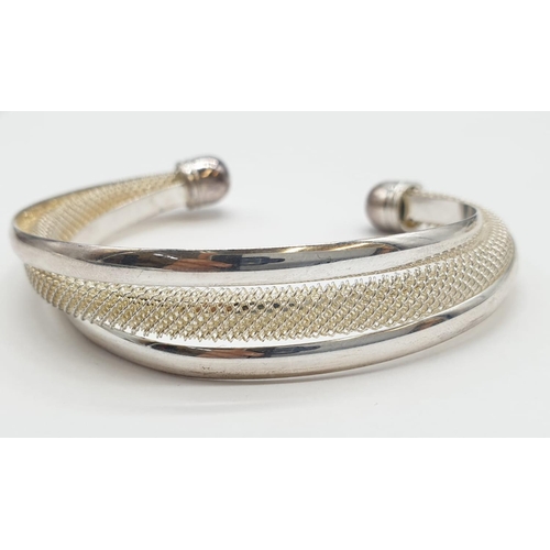 171 - Two 'Tiffany style' twisted German, silver outer layer bracelets. 7cm in diameter.