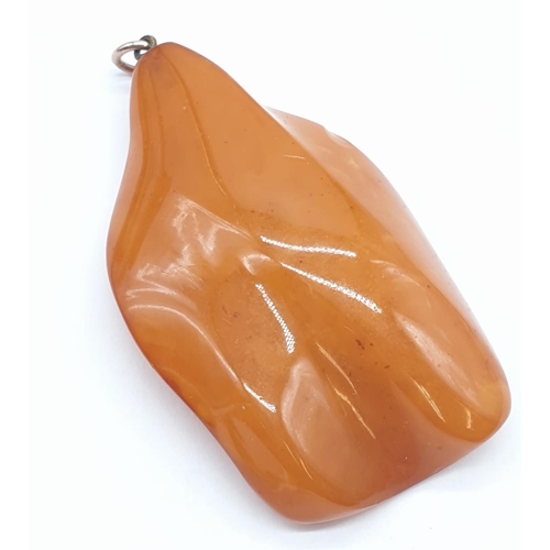 184 - Three amber pendants.