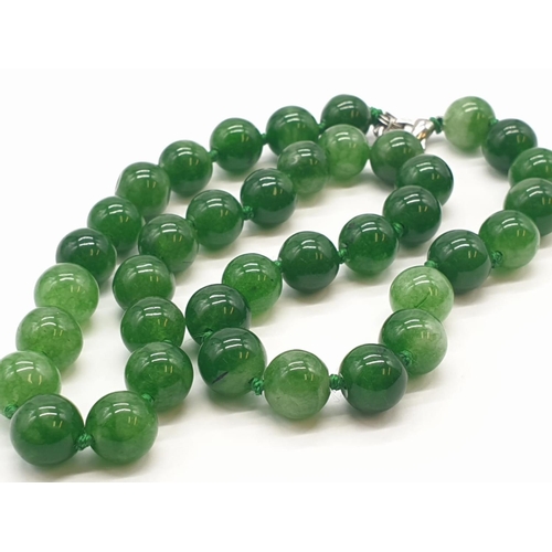 214 - Green jade necklace individually knotted, 52.8g weight and 40cm long approx