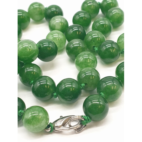 214 - Green jade necklace individually knotted, 52.8g weight and 40cm long approx