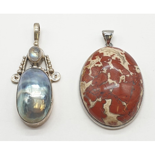 353 - Two large silver pendants one with mother of pearl, 38.2 grams total and 4.5cm long approx.