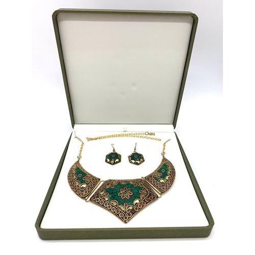 101 - A traditional, Eastern style necklace and earrings with malachite and red coral, in a presentation b... 