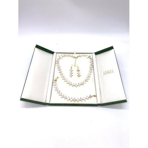 108 - A highly unusual, white pearl necklace, bracelet and earrings set in a presentation box. Silver (sta... 