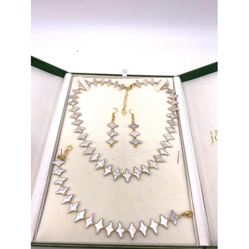 108 - A highly unusual, white pearl necklace, bracelet and earrings set in a presentation box. Silver (sta... 