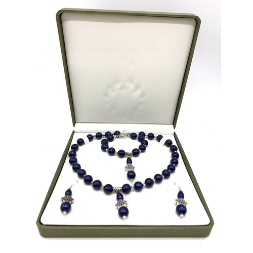 111 - A Tibetan silver and lapis lazuli necklace, bracelet and earrings set in a presentation box. Necklac... 