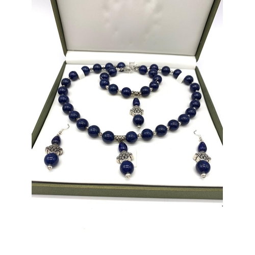 111 - A Tibetan silver and lapis lazuli necklace, bracelet and earrings set in a presentation box. Necklac... 