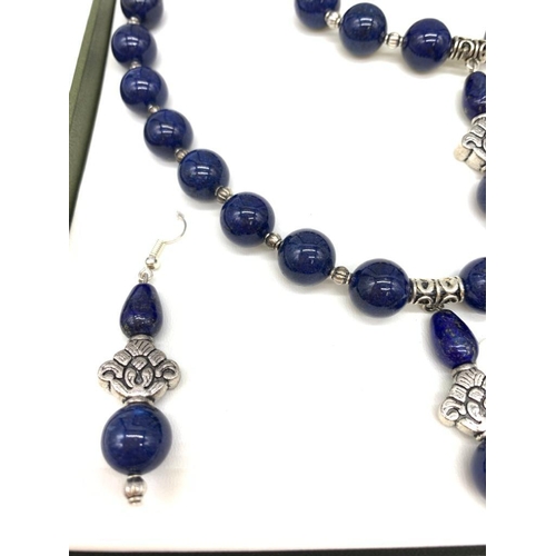 111 - A Tibetan silver and lapis lazuli necklace, bracelet and earrings set in a presentation box. Necklac... 