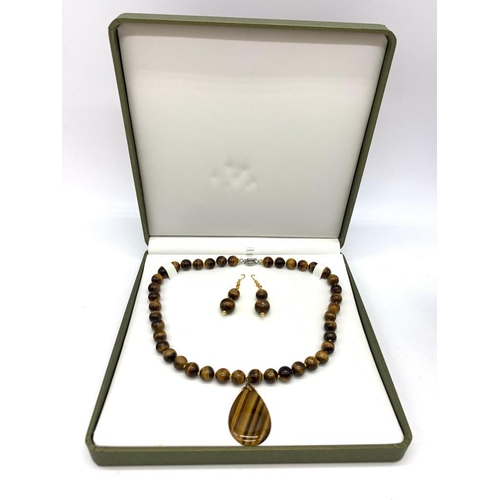 147 - A tiger’s eye necklace and earrings set in a presentation box. Necklace Length: 46 cm, earrings leng... 