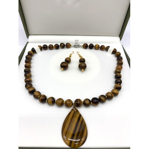 147 - A tiger’s eye necklace and earrings set in a presentation box. Necklace Length: 46 cm, earrings leng... 