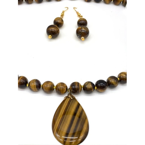 147 - A tiger’s eye necklace and earrings set in a presentation box. Necklace Length: 46 cm, earrings leng... 