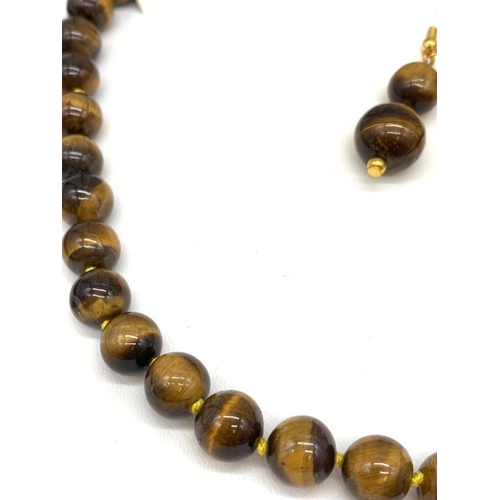 147 - A tiger’s eye necklace and earrings set in a presentation box. Necklace Length: 46 cm, earrings leng... 