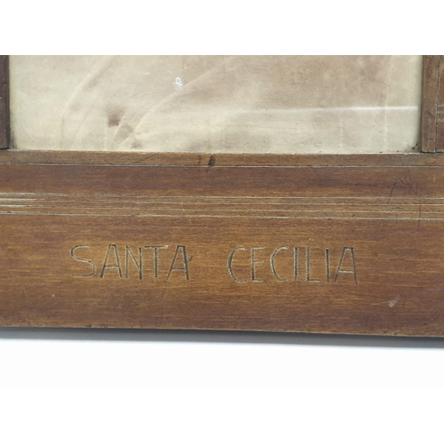 192 - A Santa Cecilia profile image in a wood frame. 26cm x 38cm.