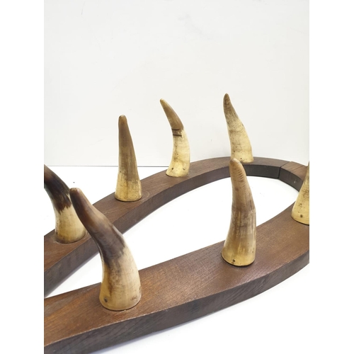 206 - Horn gun rack early 20th century with wood shield in shape of horse collar, 4 pairs of horn, 97 x 43... 