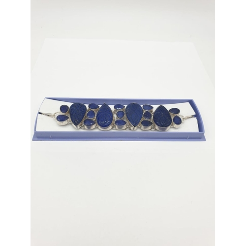 32 - A statement bracelet with carved, transluscent, cabochon sapphires.
Bracelet length: 19cm (max), wei... 