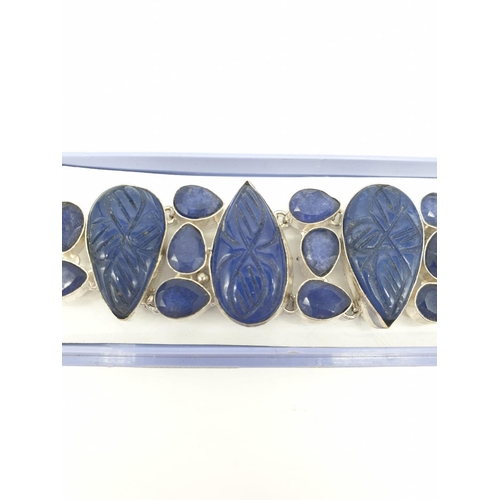 32 - A statement bracelet with carved, transluscent, cabochon sapphires.
Bracelet length: 19cm (max), wei... 